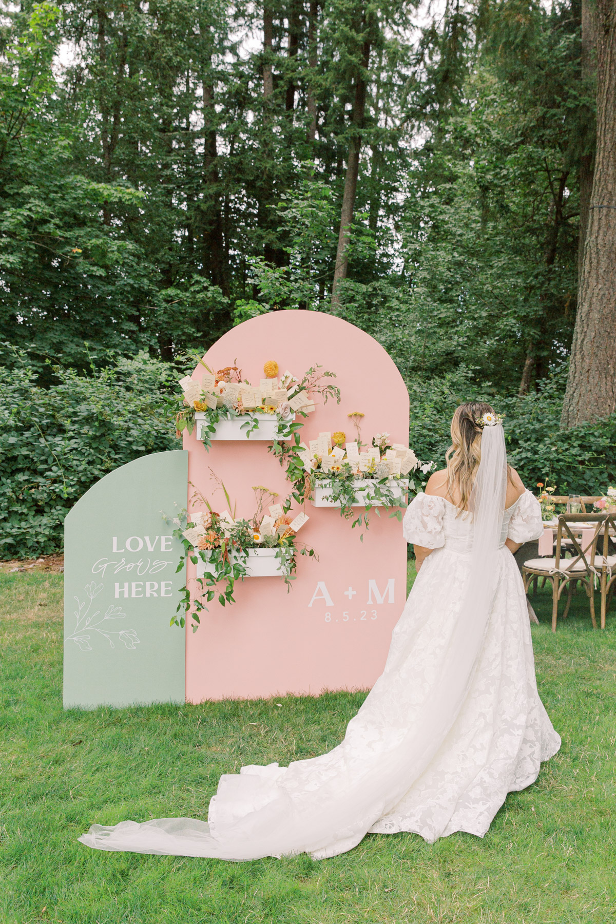 Bride standing in front of Custon Day-of Signage by Life in Letters